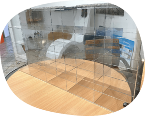 a clear plastic shelf on top of a wooden table.