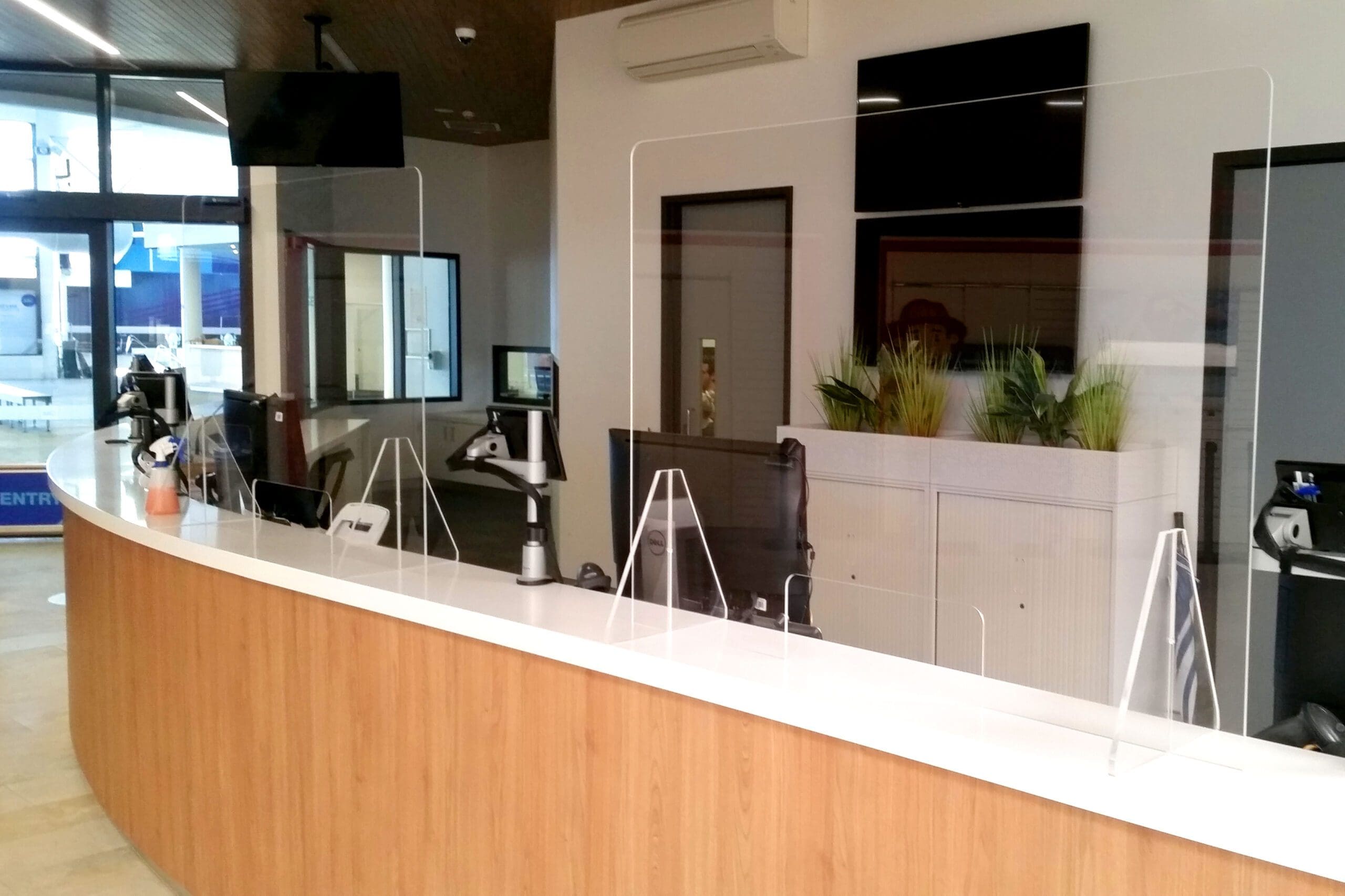 a counter with a bunch of Sneeze Guards on top of it.