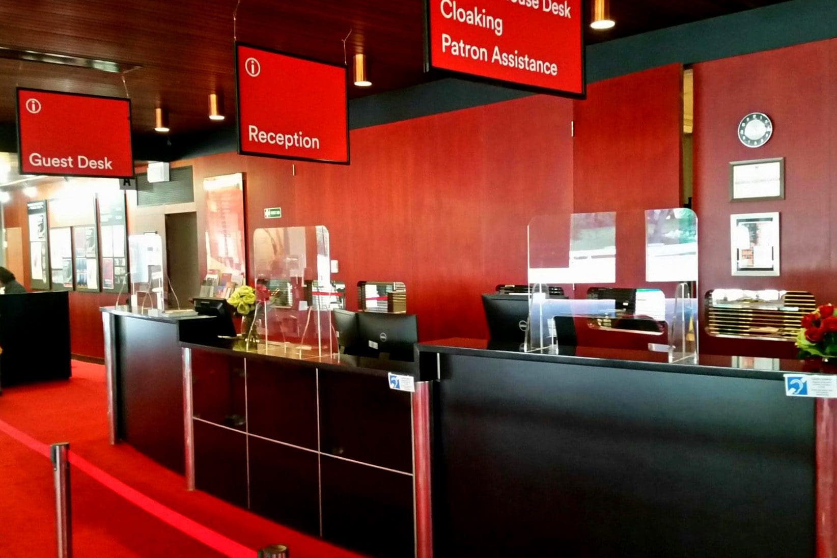 a red and black restaurant with Sneeze Guards on the counters.