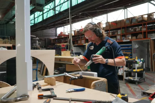 a man working on a piece of wood.